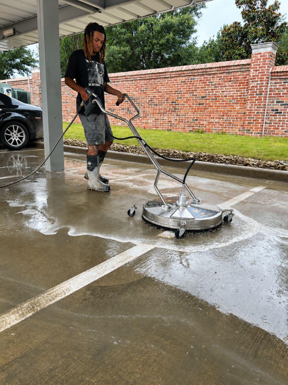 Crew running a surface cleaner across commercial concrete in DFW